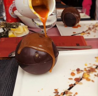 Hot caramel on chocolate ball at Rifugio La Roda by placescases