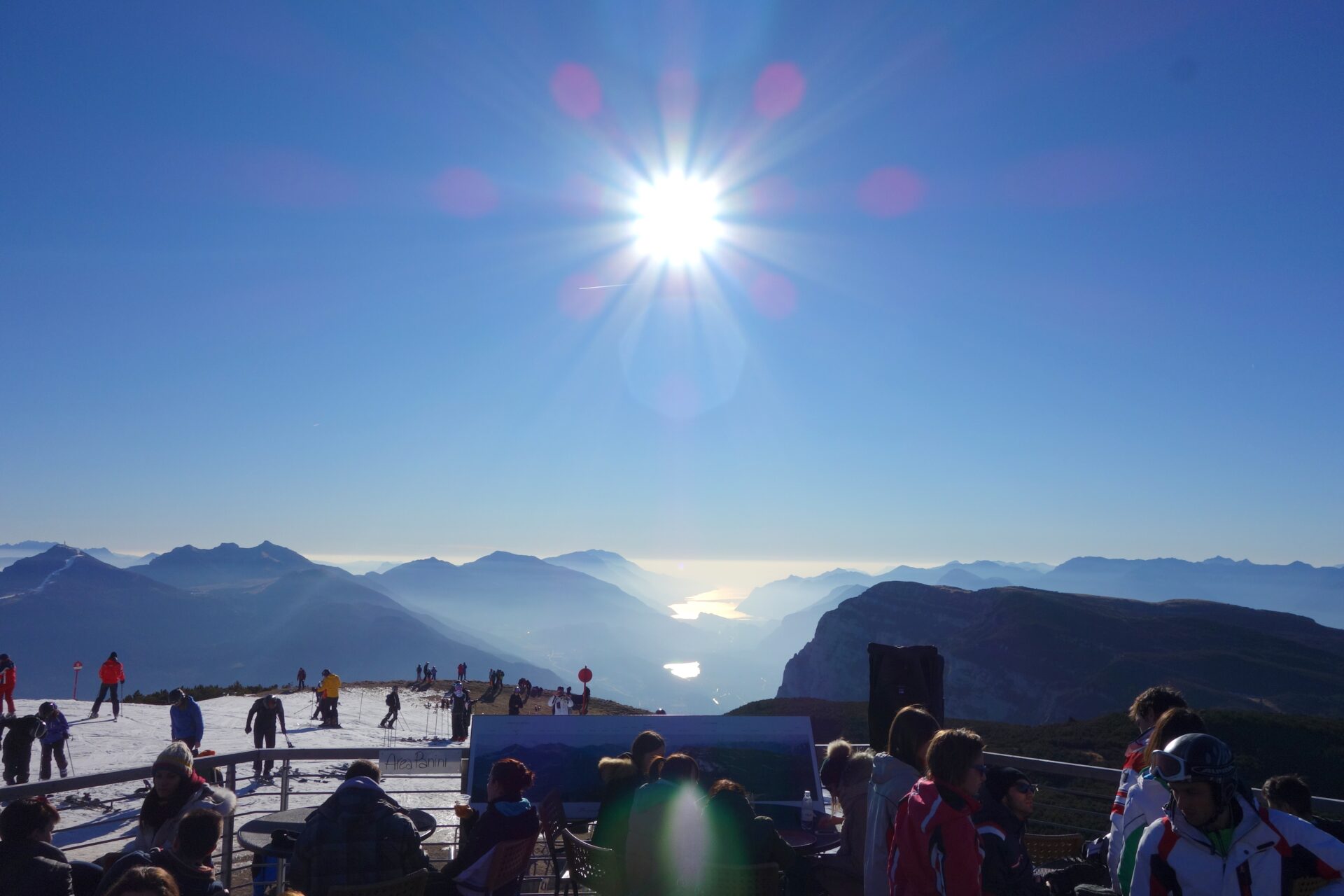 View to the sun and the lake from the terrace of Rifugio La Roda by placescases