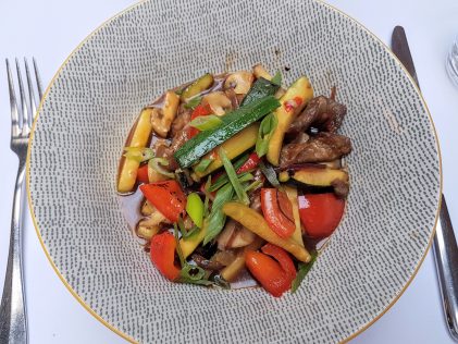 Dish made in wok at restaurant Apetit, placescases.com